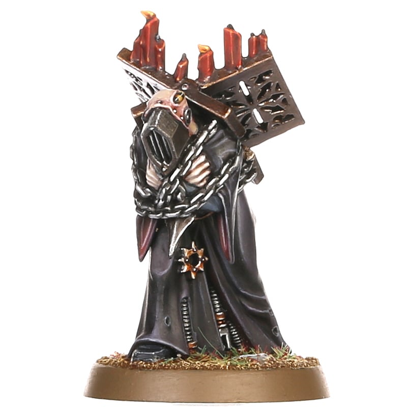 Warhammer 40,000 - Chaos Space Marines - Dark Apostle - Dark Apostle figure in black and metallic armor with chains and red candles on a spiked headdress, standing on a textured.