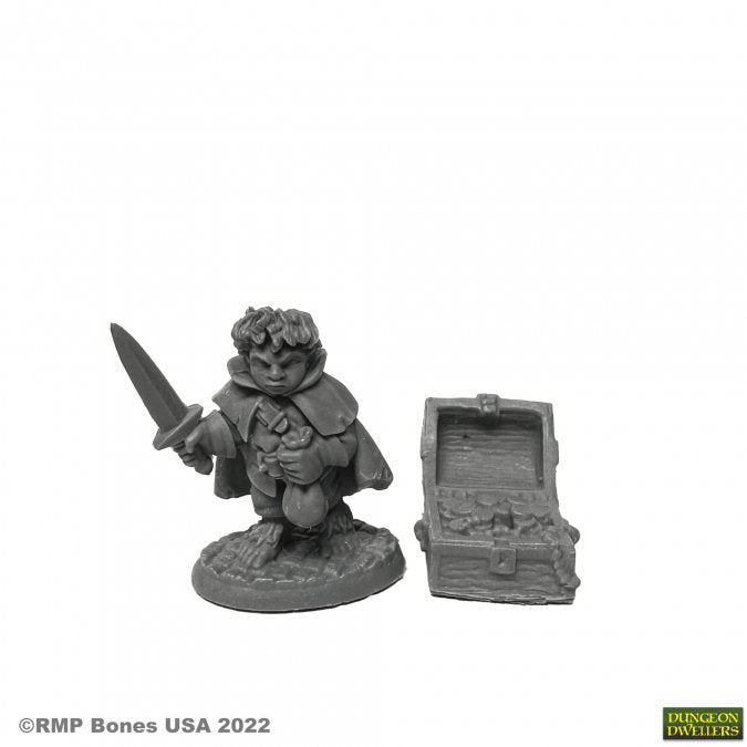 Stitch Thimbletoe, Halfling Thief - Gray unpainted halfling thief miniature holding a dagger with a treasure chest on a round base.