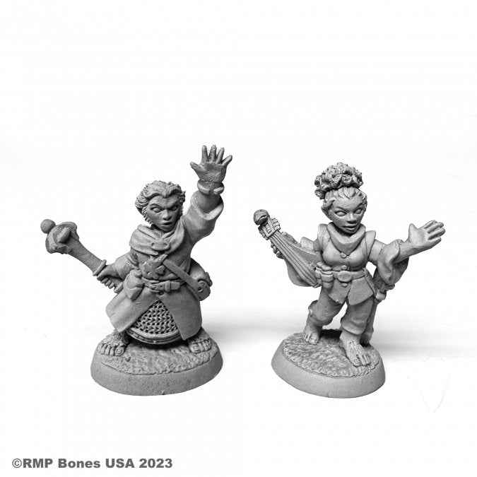 Halfling Cleric and Bard - Two unpainted gray resin miniatures of halflings; one dressed as a cleric with raised hand and mace, the other as a bard.
