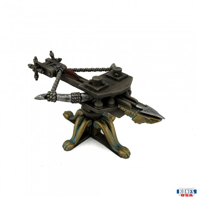 Sharkbite Ballista - Dark metal ballista model with detailed crossbow arms and ornate tripod base with gold and green accents.