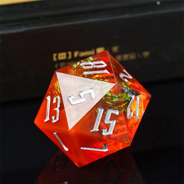 33mm Orange & Silver Numbers D20 - 33mm translucent orange 20-sided die with silver numbers and reflective inclusions.
