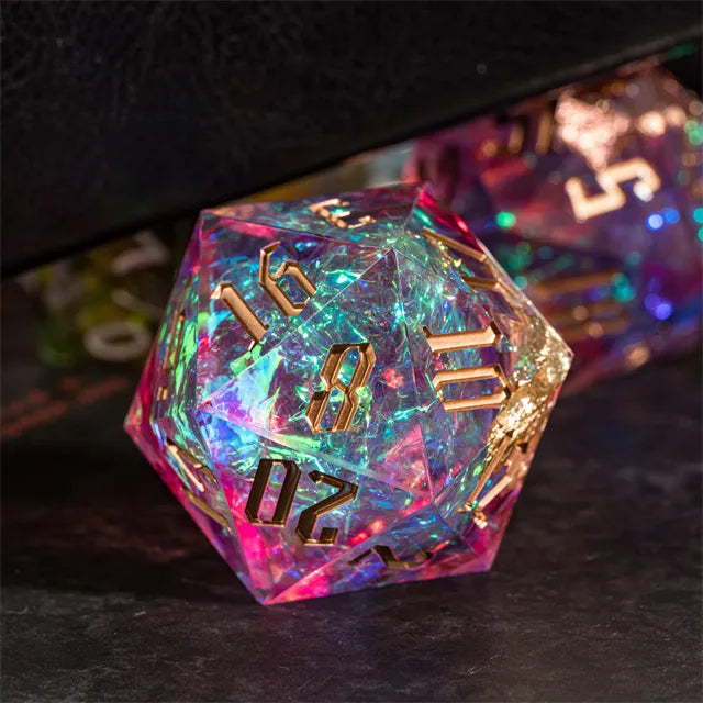 33mm Pink Shimmer D20 - 33mm pink shimmer d20 dice with iridescent glitter and gold numbers on black surface.