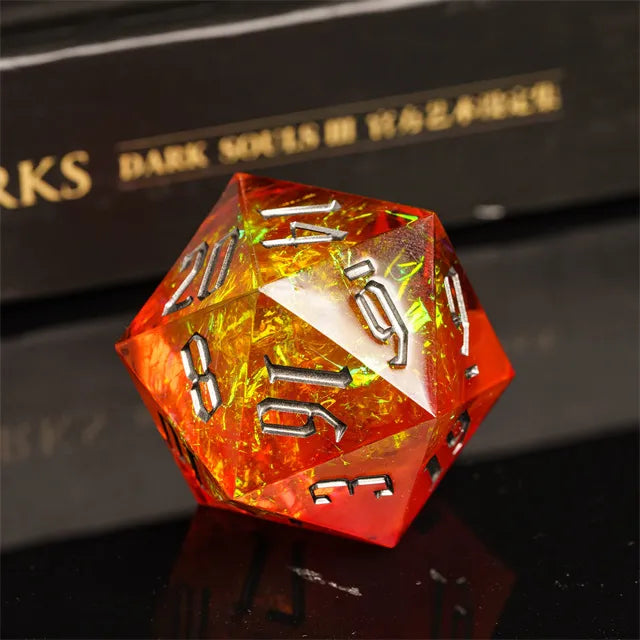 33mm Orange & Dark Numbers D20 - 33mm translucent orange d20 die with dark metallic numbers on a reflective surface.