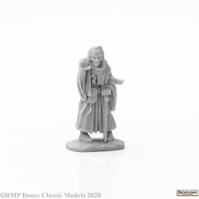 Estra, Iconic Spiritualist - Gray resin miniature figurine of an elderly woman in a flowing robe holding a staff and a small container, standing on an.