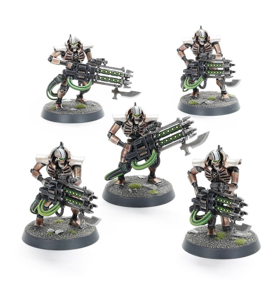 Warhammer 40,000 - Necrons - Immortals - Five metallic skeleton-like figures with green glowing accents wielding large futuristic guns, posed on textured black bases.