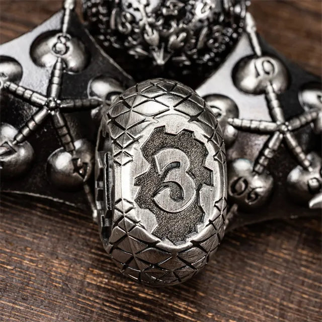 Dragon Theme Metal Dice - Metal gaming die with dragon scale pattern and etched number 3, surrounded by ornate skull and crossbones dice.