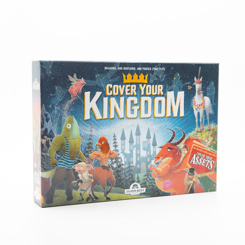 Cover Your Kingdom - Cover Your Kingdom card game box featuring colorful fantasy characters and castle towers background.
