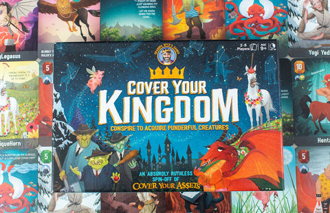 Cover Your Kingdom - Rectangular board game box with fantasy artwork featuring a castle, dragon, and creatures, titled "Cover Your Kingdom" in.
