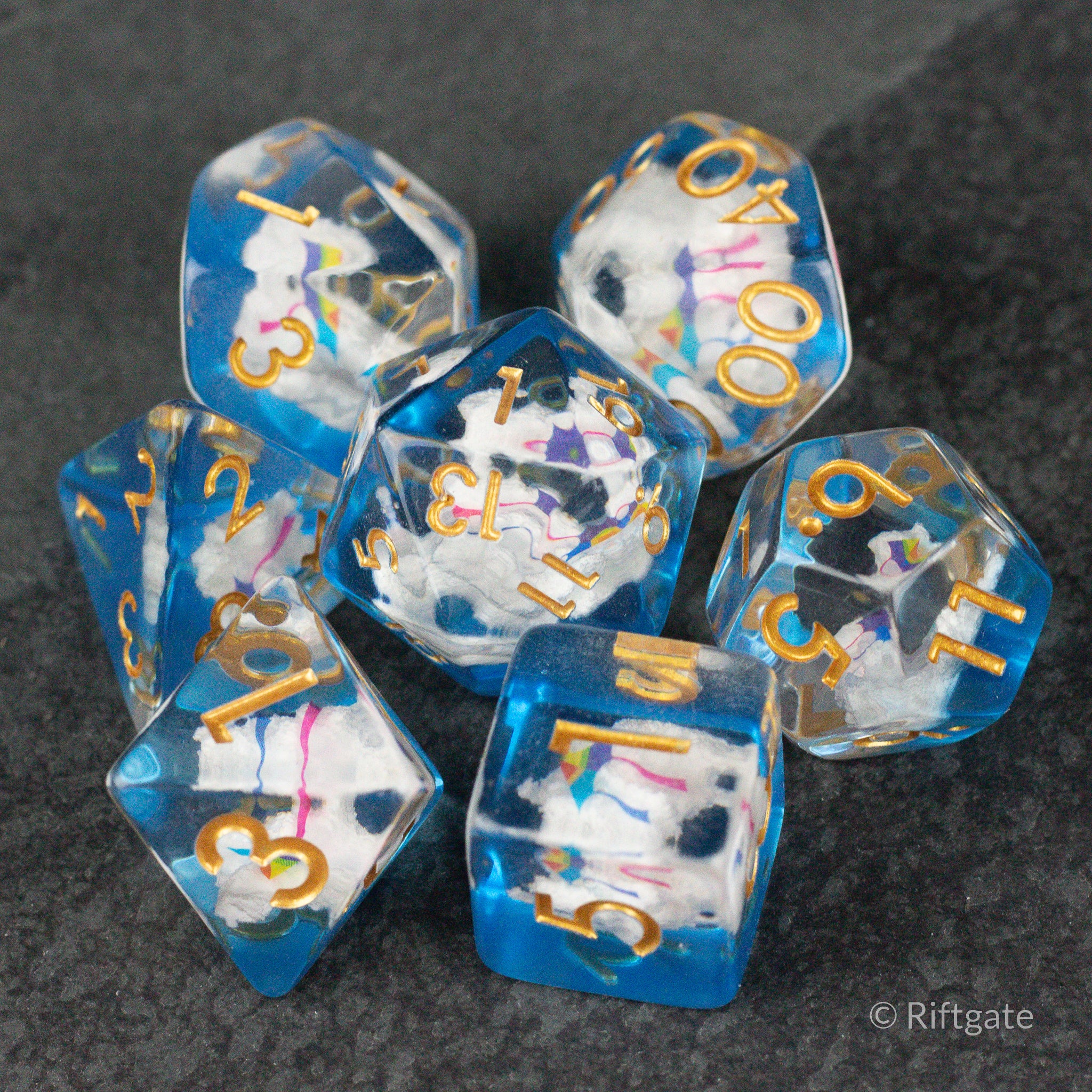 Clouds & Kites Dice - Set of six blue translucent polyhedral dice with colorful cloud and kite inclusions and gold numbers.