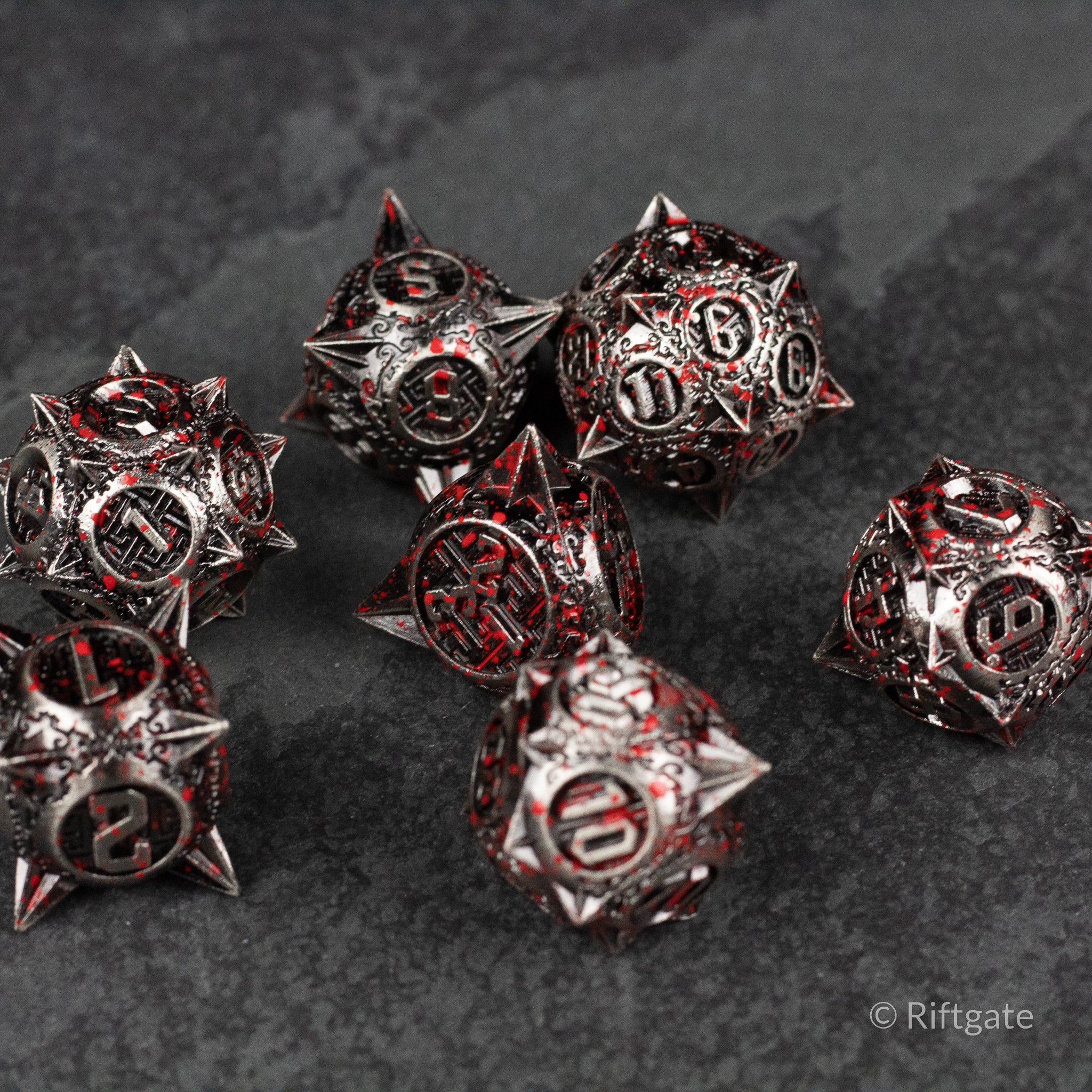 Bloody Morning Star Metal Dice Set - Set of black metal polyhedral dice with red accents and spiked edges, featuring white numbers.