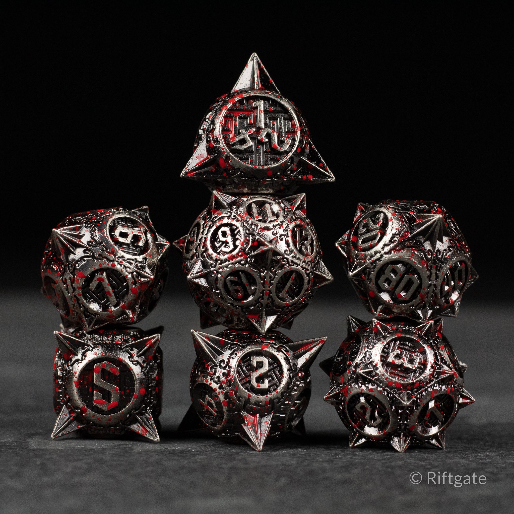 Bloody Morning Star Metal Dice Set - Set of seven metal polyhedral dice with black and silver finish, red blood splatter design, and sharp edged spikes on select