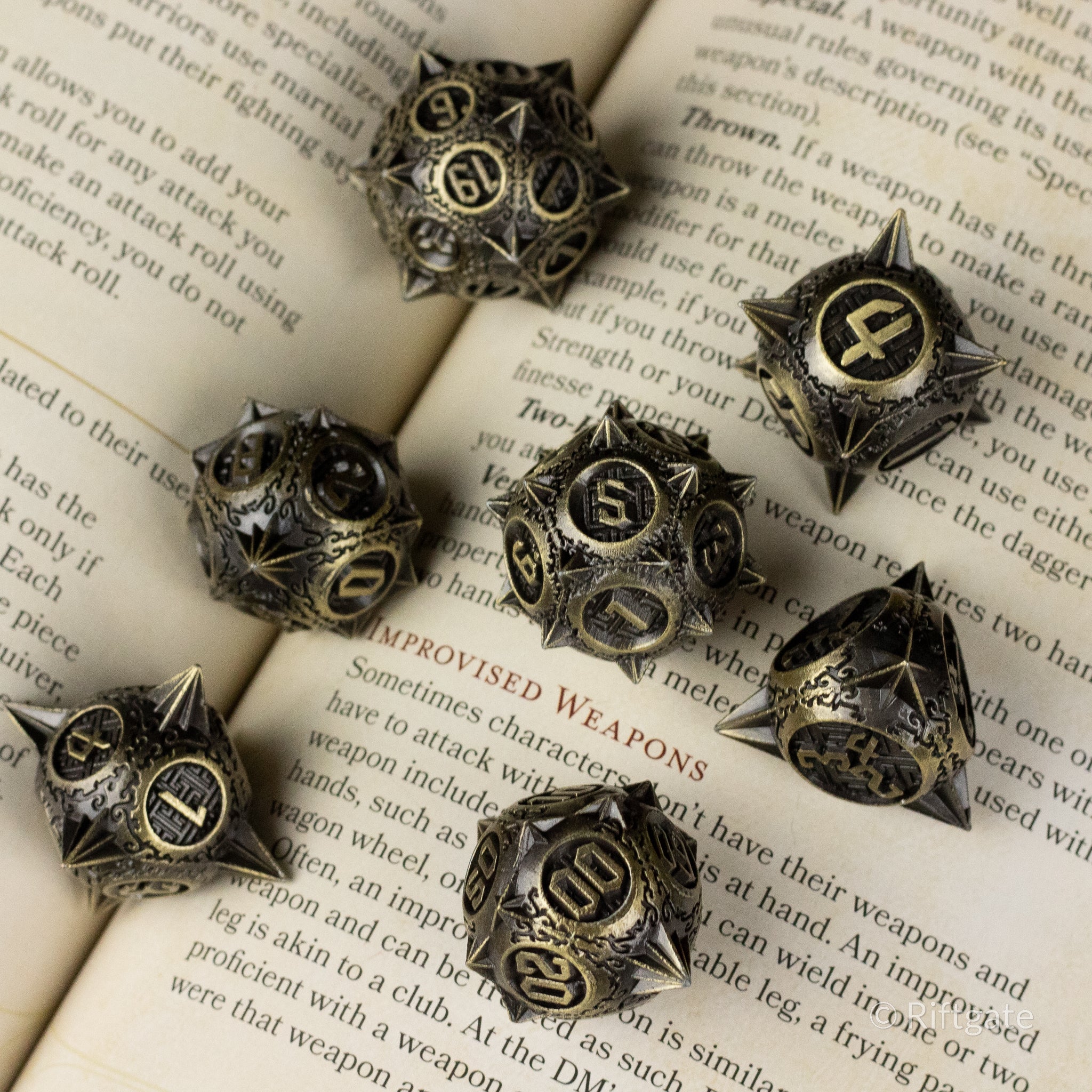 Bronze Morning Star Metal Dice Set - Bronze metal polyhedral dice set with engraved numbers in dark recesses, styled with sharp edges and a medieval design.