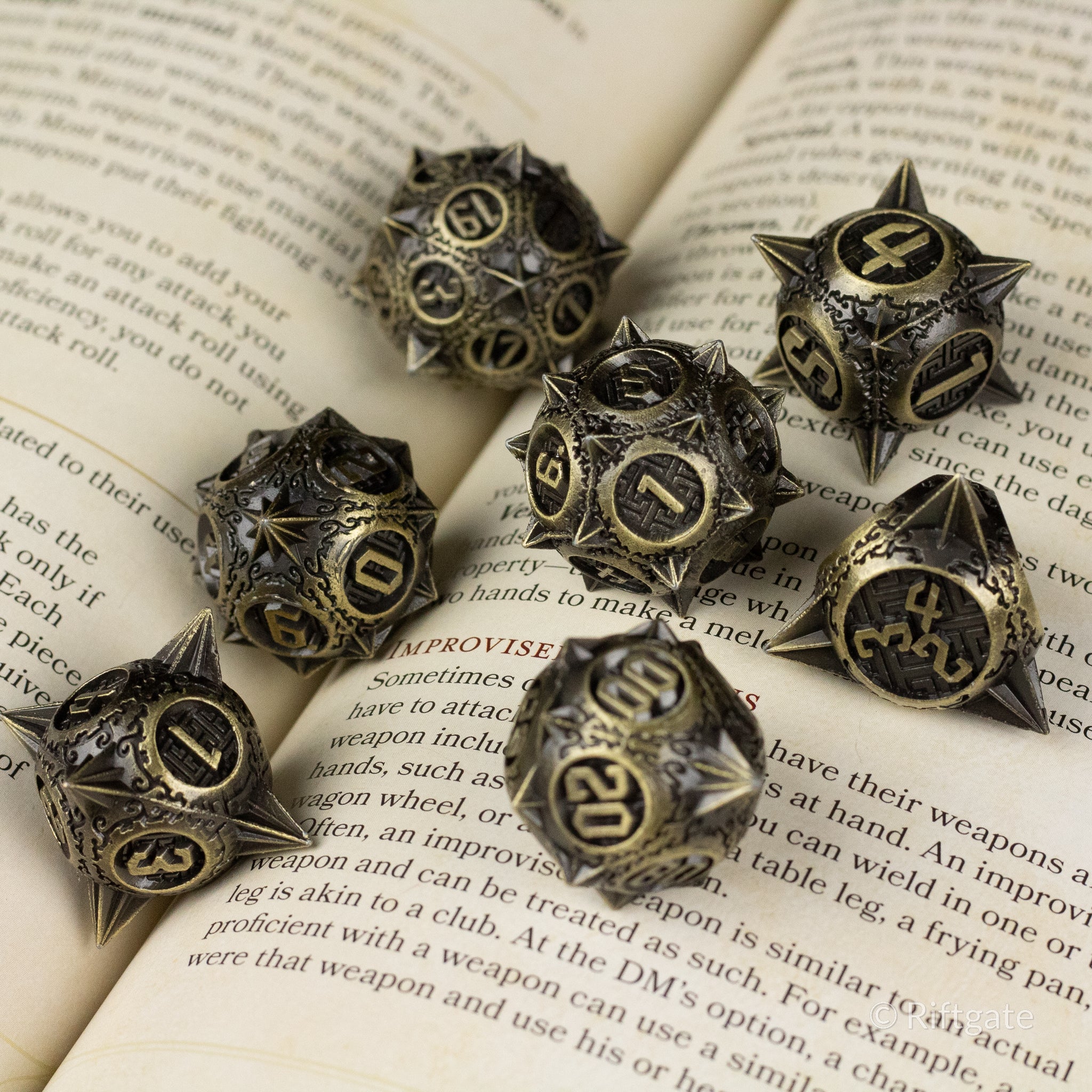 Bronze Morning Star Metal Dice Set - Bronze metal dice set with intricate spiked star and spherical shapes, black etched numbers.