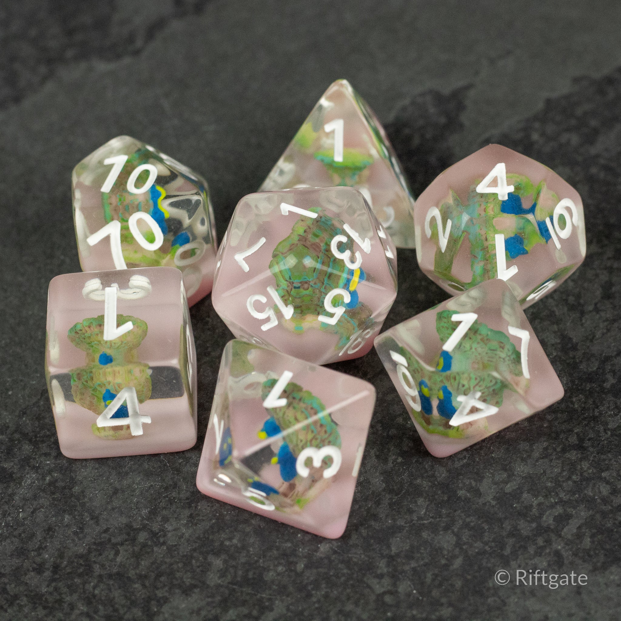 Peacock Dice Set - Clear polyhedral dice set with embedded colorful peacock feather designs and white numbering.
