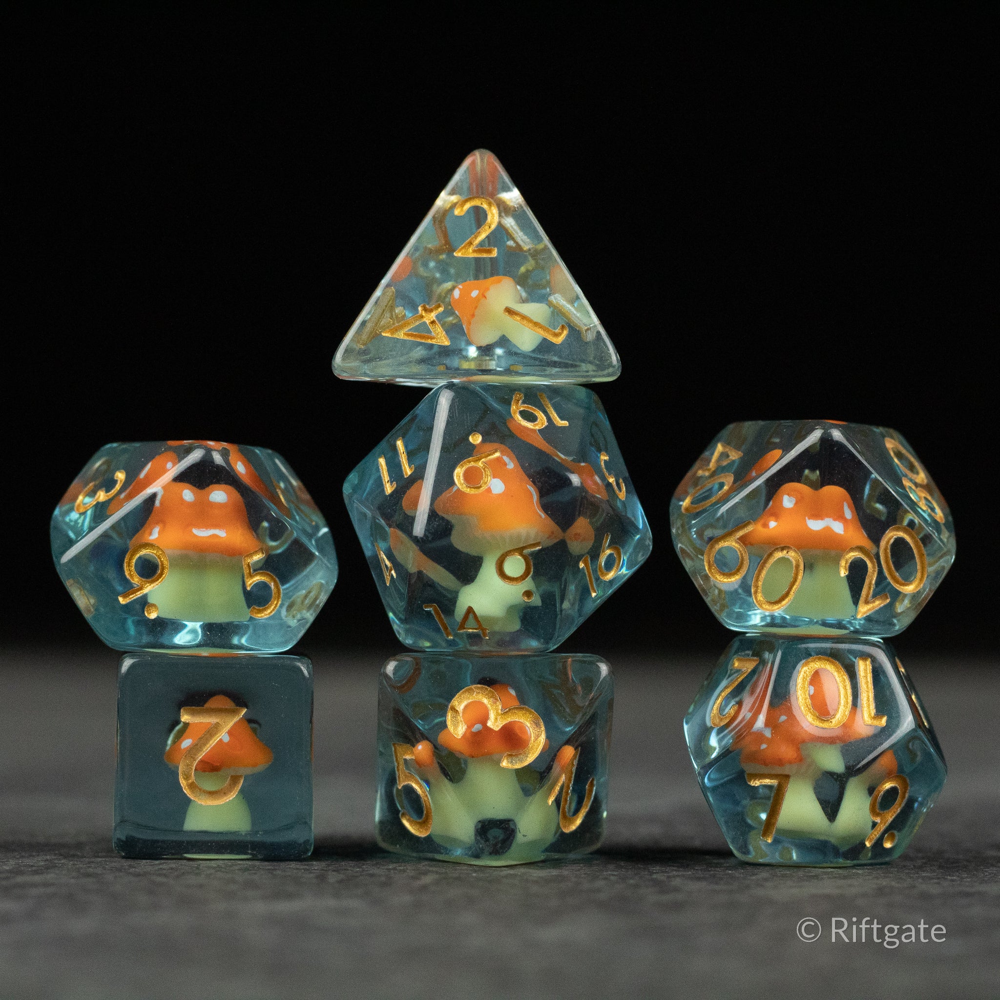 Orange + Blue Resin Mushroom Dice Set - Set of six translucent resin dice with orange and blue mushroom inclusions, gold numbers, various polyhedral shapes.