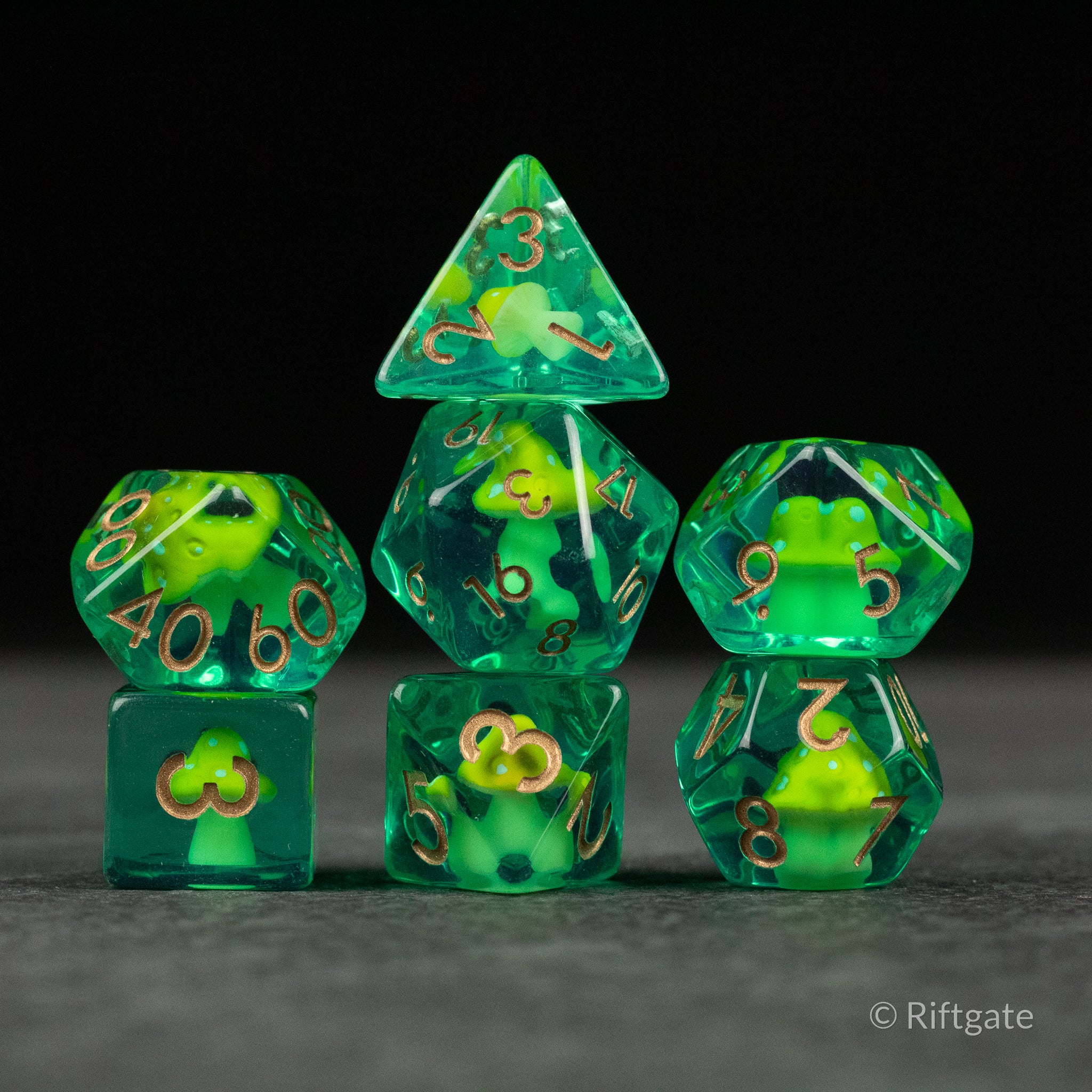Yellow + Green Resin Mushroom Dice Set - Green and yellow translucent resin dice set with mushroom and clover inclusions, gold numbering.