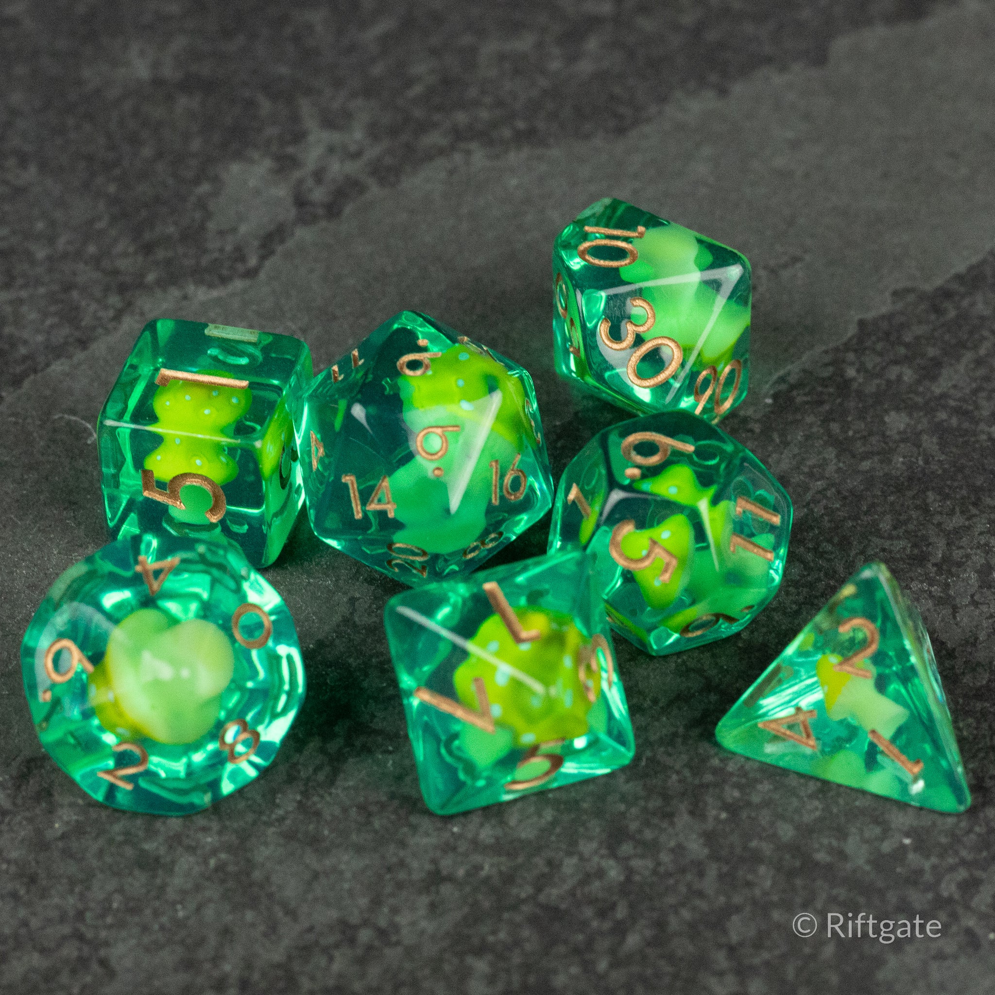 Yellow + Green Resin Mushroom Dice Set - Green and yellow resin polyhedral dice set with embedded mushroom inclusions and gold numbers.