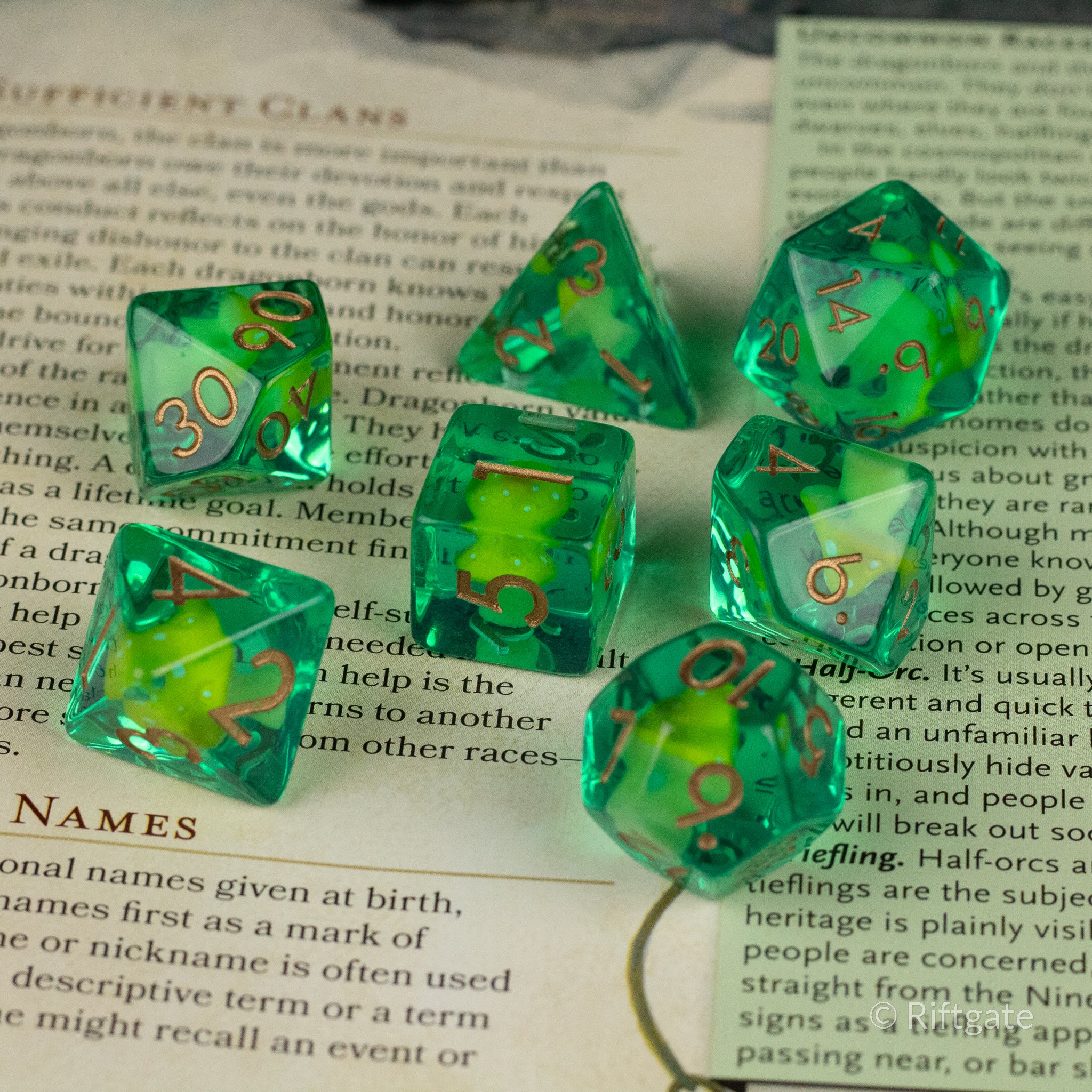 Yellow + Green Resin Mushroom Dice Set - Green resin dice with yellow mushroom-shaped inclusions and gold numbers on a book background.