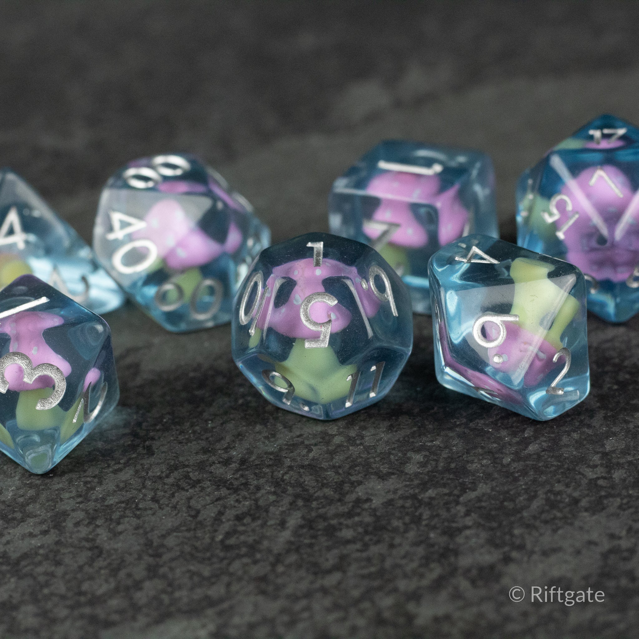 Pink + Blue Resin Mushroom Dice Set - Set of translucent resin dice with pink and blue mushroom-shaped inclusions and white numbering.