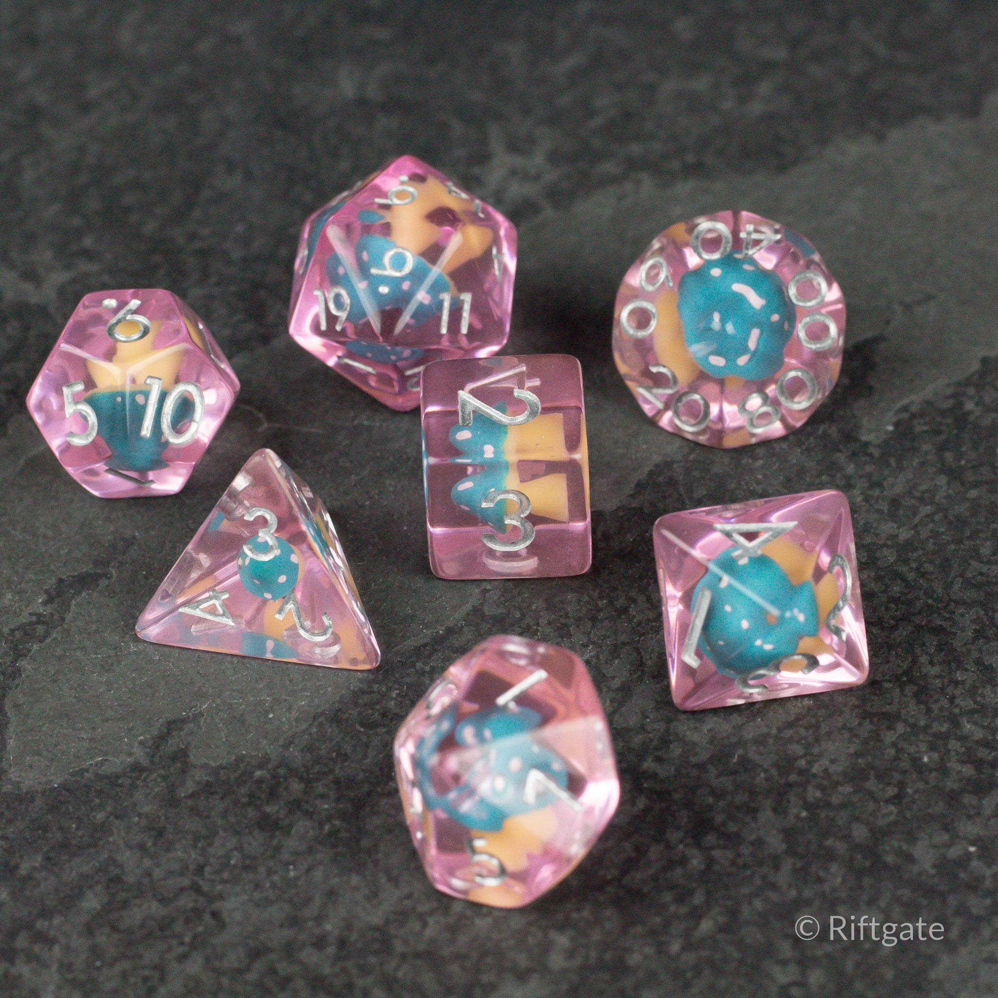 Blue + Pink Resin Mushroom Dice Set - Blue and pink translucent resin dice set with embedded mushroom shapes, various polyhedral styles.