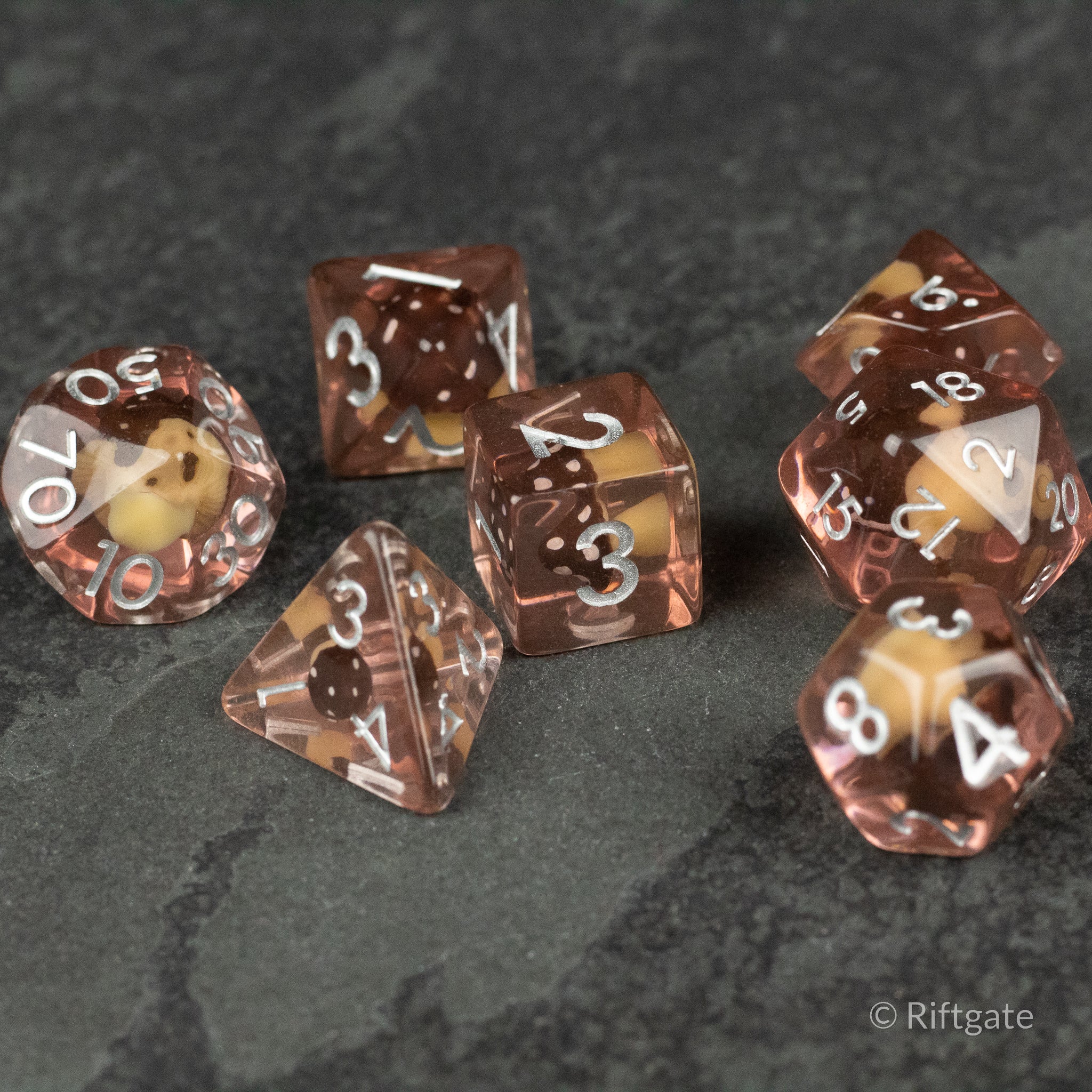 Coffee + Brown Resin Mushroom Dice Set - Seven-piece coffee brown resin dice set with a small mushroom inclusion and white numbering.