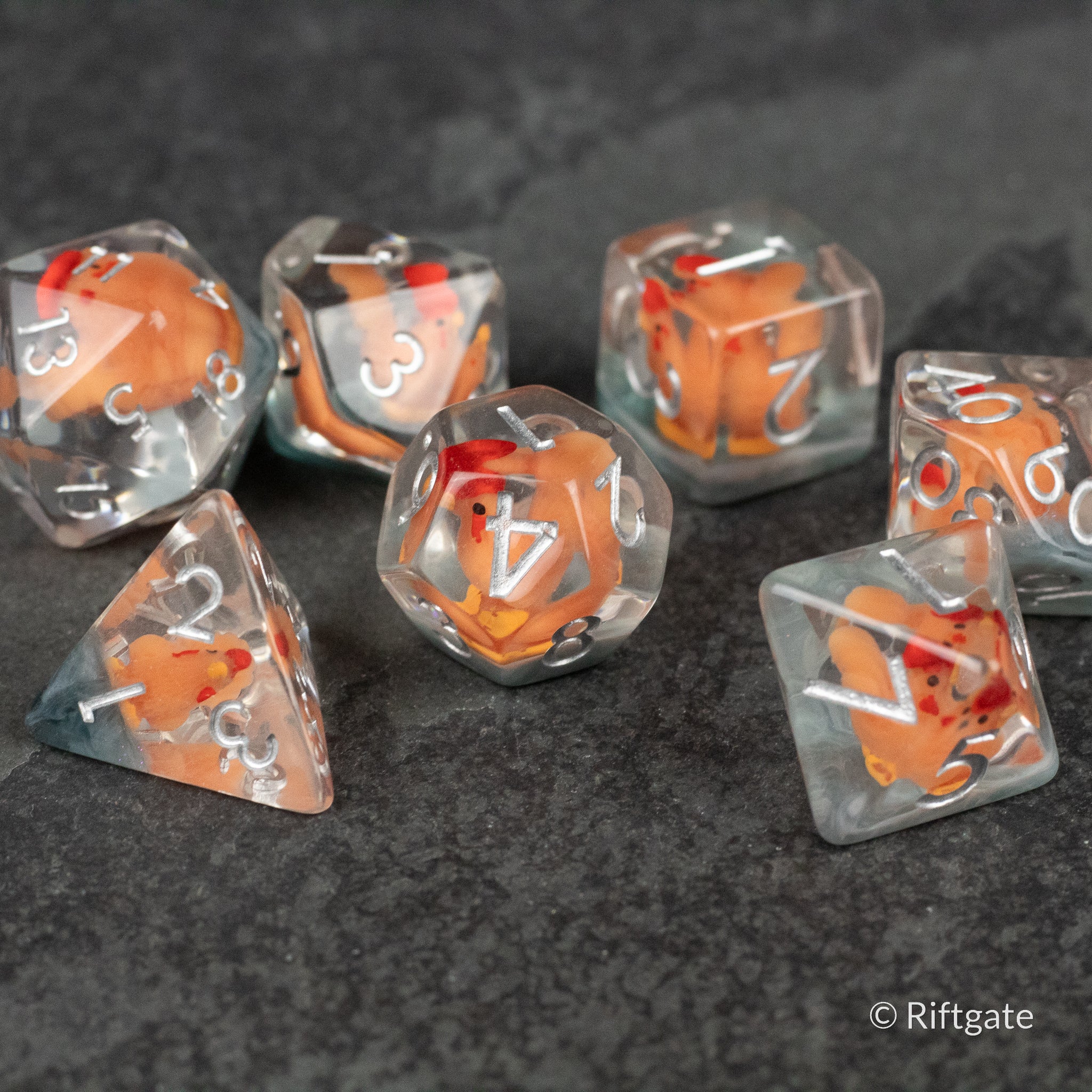 Chicken Dice Set - Set of seven clear polyhedral dice with orange and red chicken figures inside, white numbering.