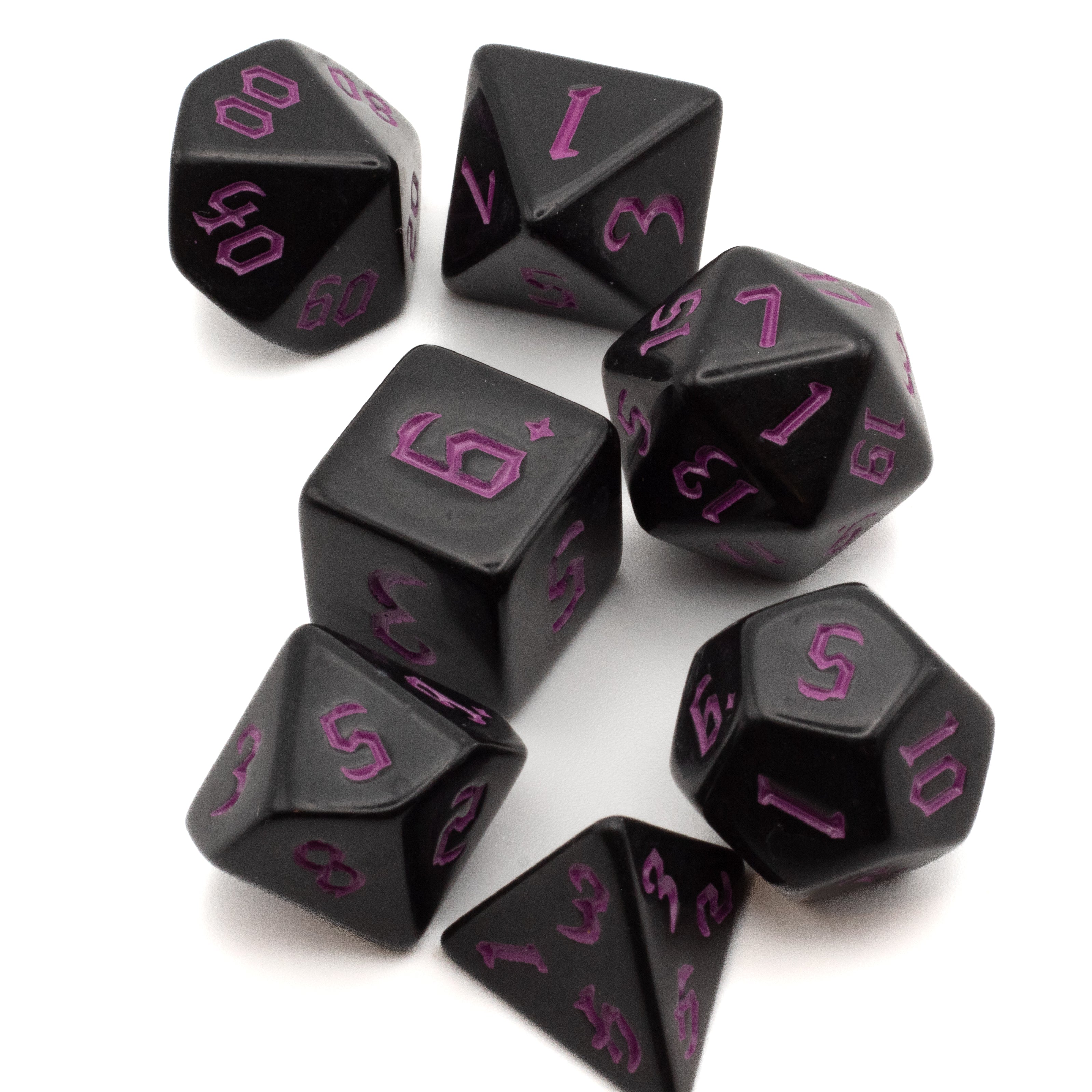 Black Acrylic Dice Set - Pink - Seven black acrylic polyhedral dice with pink numbers, including d20, d12, d10, d8, d6, d4, and percentile dice.