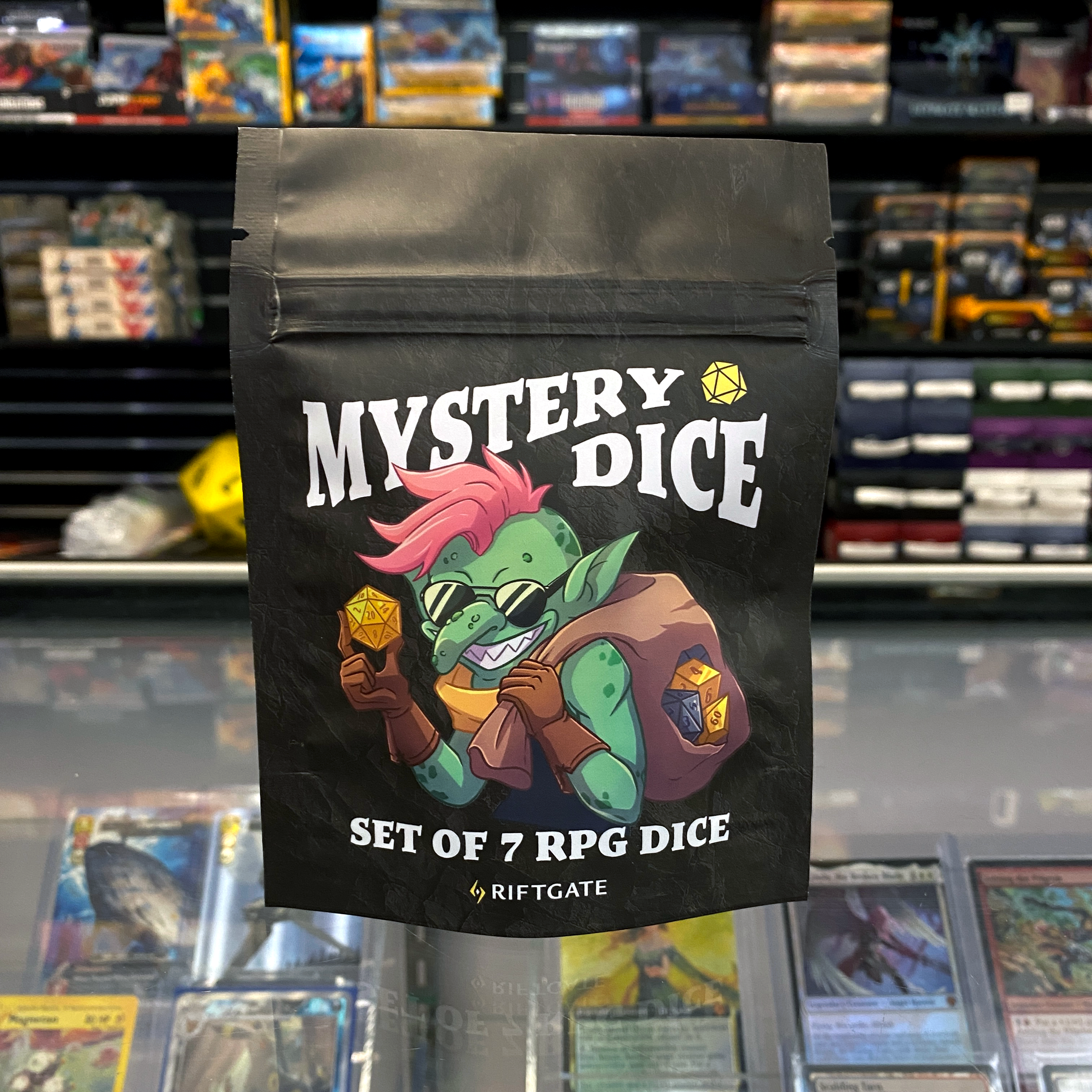 Mystery Dice Booster Pack - Black resealable bag with colorful goblin holding RPG dice, labeled "Mystery Dice Set of 7 RPG Dice".