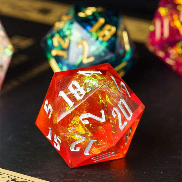 33mm Orange & Silver Numbers D20 - 33mm transparent orange d20 die with silver numbers and internal gold foil accents.
