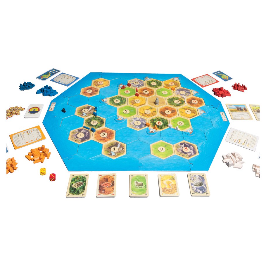 Catan Expansion: Seafarers - Catan Seafarers board game with hexagonal terrain tiles, blue sea tiles, resource cards, numbered tokens, and wooden game.