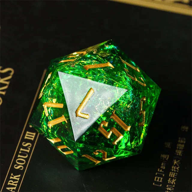 33mm Green Shimmer D20 - 33mm transparent green shimmer d20 with gold numbers and beveled edges on a dark surface.