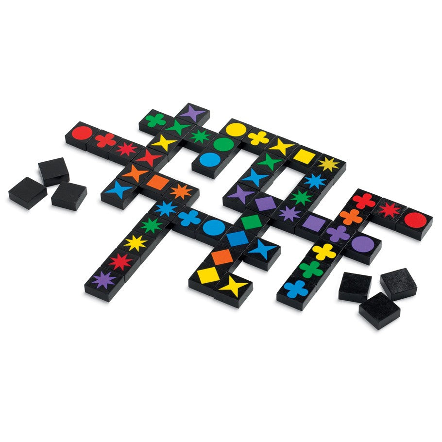 Qwirkle - Qwirkle game tiles with colorful geometric shapes arranged on a black grid board.