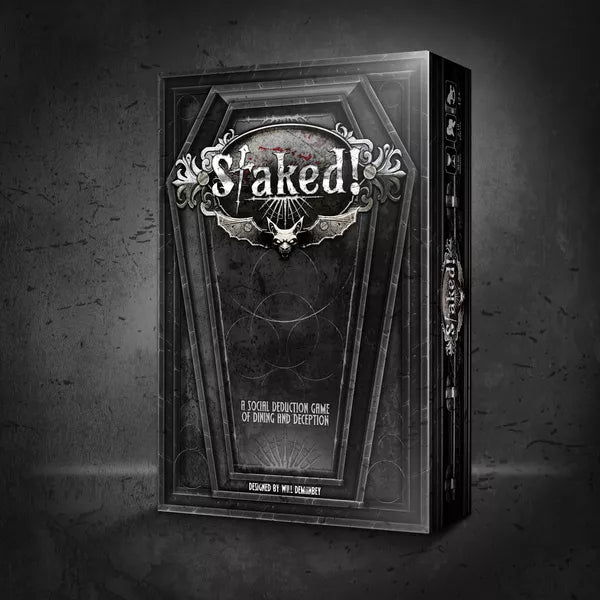Staked! - Dark gray coffin-shaped box with gothic silver lettering and ornate skull design on the front.