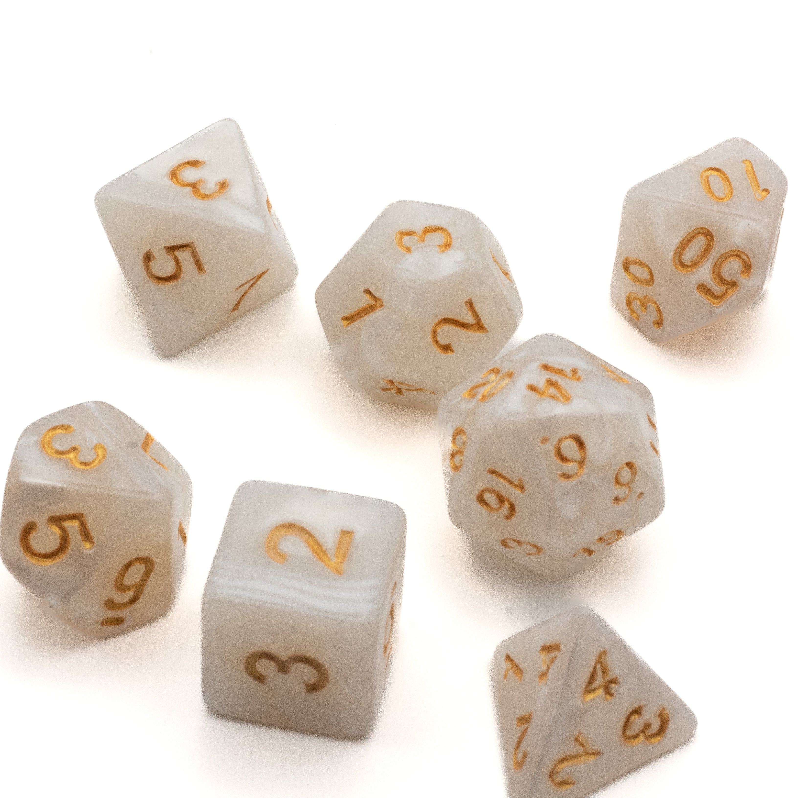 White Marbled Acrylic Dice Set - White marbled acrylic seven-dice set with gold numbering including d4, d6, d8, d10, d12, and d20.