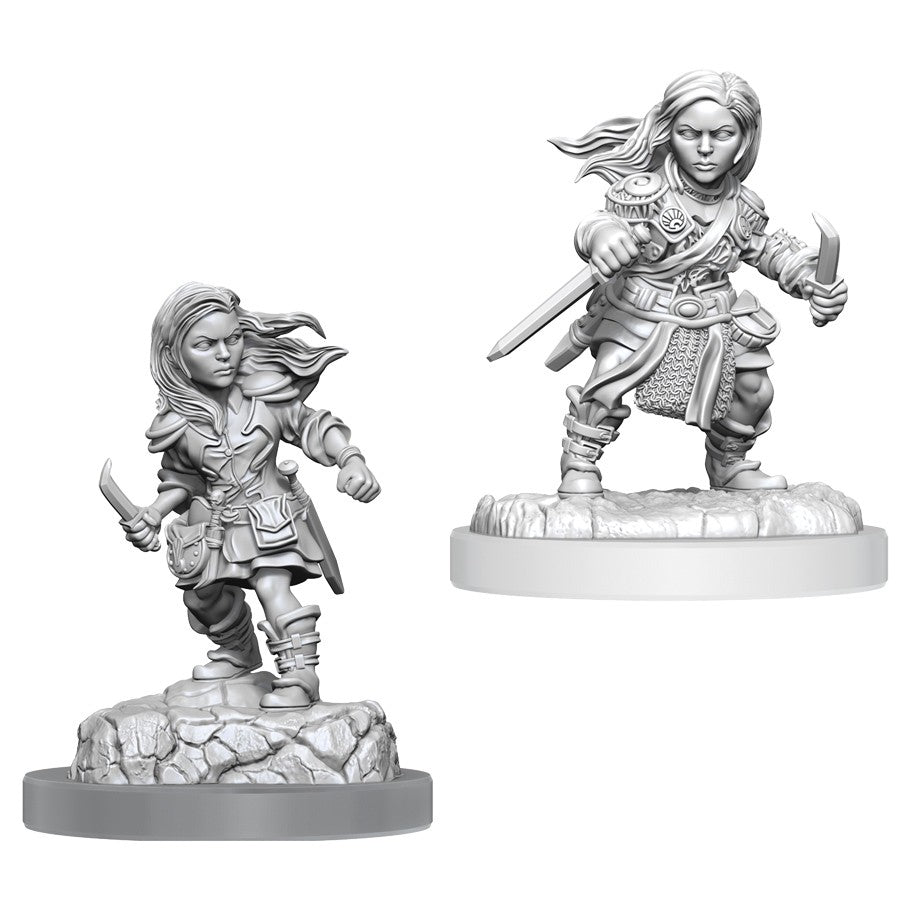 Dungeons & Dragons: Nolzur's Marvelous Minis: Halfling Rogue Female - Unpainted female halfling rogue miniature with flowing hair, dual daggers, and detailed armor on rocky bases.