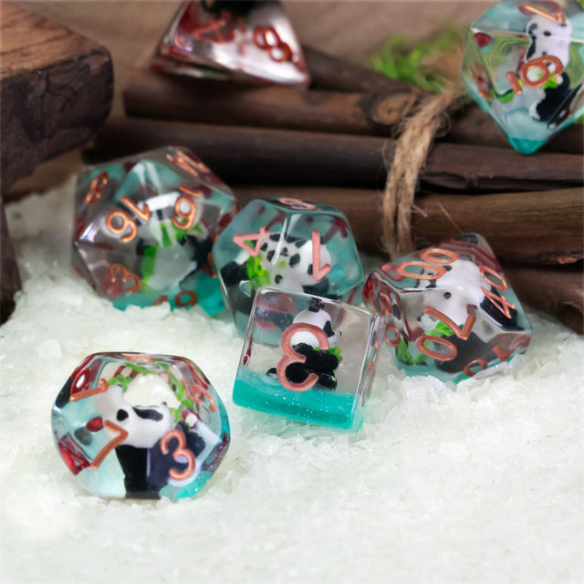 Panda & Bamboo Dice Set - Set of seven translucent polyhedral dice with panda and bamboo illustrations and copper numbers.
