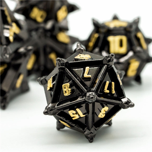 Caltrop Black Metal Dice Set - Black metal 20-sided dice with sharp caltrop spikes and gold numbers.