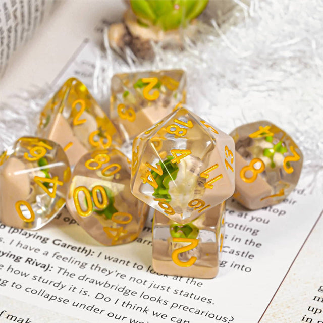 Succulent Dice Set - Clear resin dice set with embedded green and white succulent plants, gold numbering, includes multiple polyhedral shapes.
