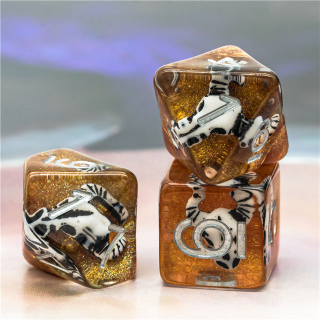 Desert Skull Dice Set - Gold and brown translucent dice set with embedded skull and bone designs, including d20, d6, and d8 shapes.