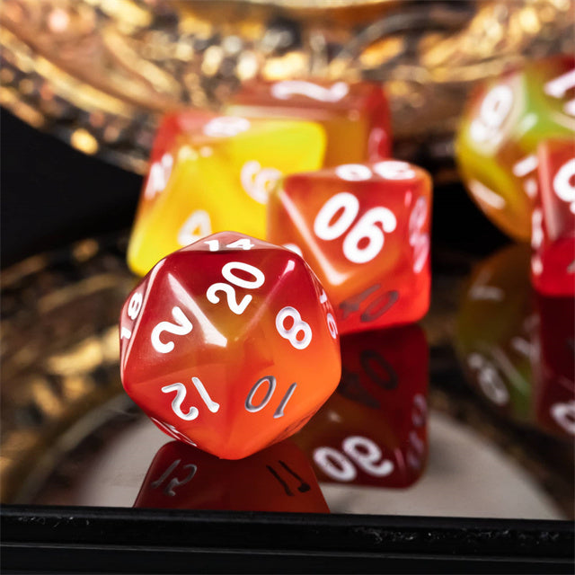 Orange & Yellow Transparent Dice - Translucent orange and yellow 20-sided acrylic dice with white numbering on a reflective black surface.
