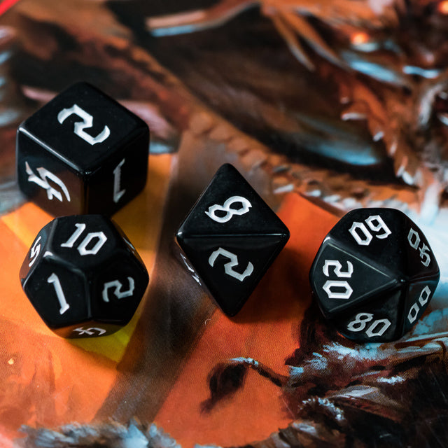 Black Acrylic Dice Set - White - Set of black acrylic dice with white numbers, including d4, d6, d8, d10, and d12 shapes.