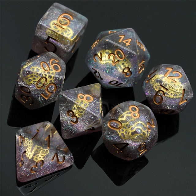 Mini Gears Dice Set - Seven miniature polyhedral dice set with steampunk gear designs, iridescent gray with gold numbers and gears.