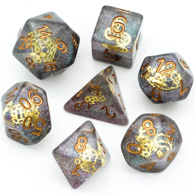 Mini Gears Dice Set - Set of seven translucent dice with embedded gold gears and orange numbers.