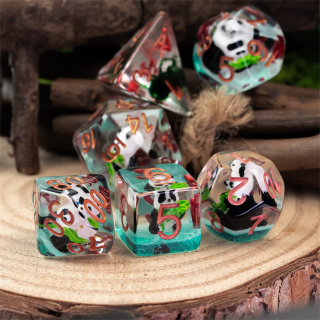 Panda & Bamboo Dice Set - Set of translucent dice with panda and bamboo illustrations, featuring red numbers on various shapes including a d20, d12,.