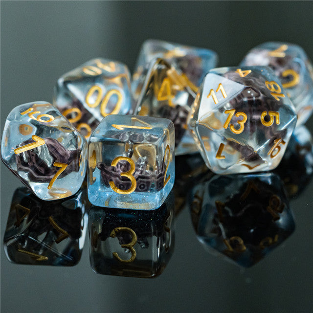 Boat Dice - Set of translucent polyhedral dice with gold numbers and miniature boat figures inside.