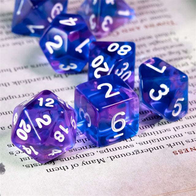 Blue & Purple Transparent Dice - Set of transparent blue and purple acrylic dice with white numbers, including d20 and d6 shapes.