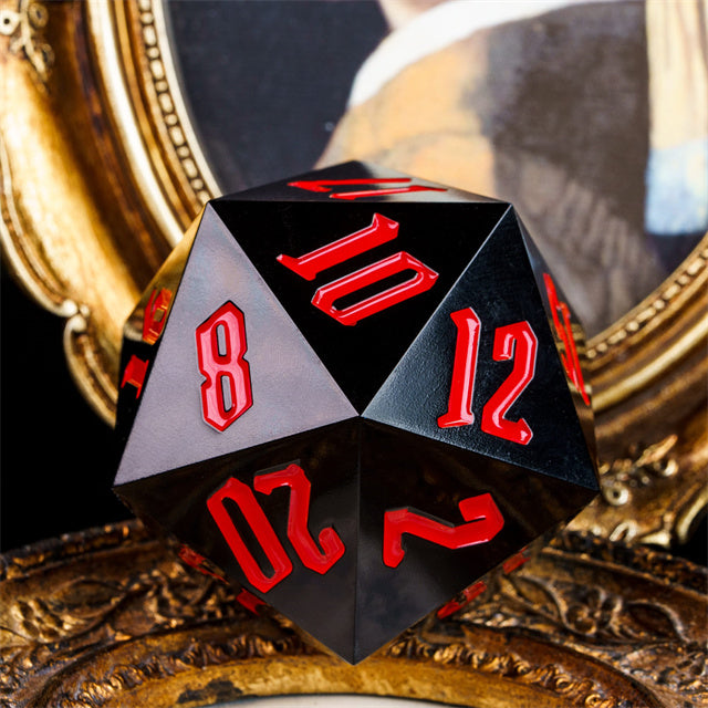 Giant 55mm D20 - Black - Black acrylic 55mm giant d20 dice with red numbers on a decorative surface.