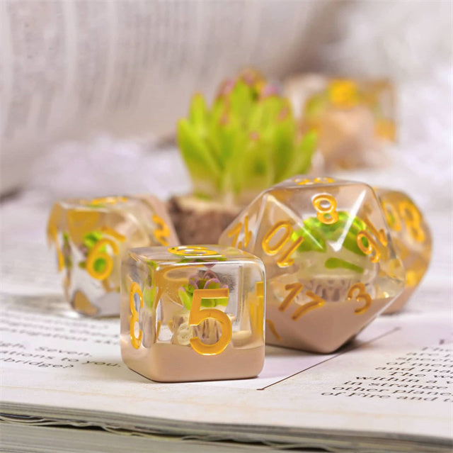 Succulent Dice Set - Clear resin dice set with embedded green succulents and gold numbers, includes d20 and d6.