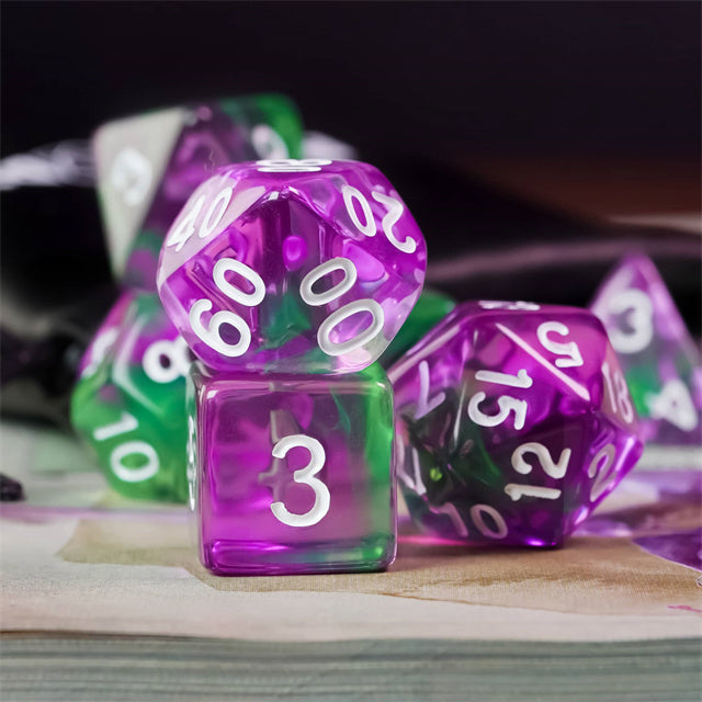 Purple & Green Transparent Dice - Set of transparent acrylic dice in purple and green with white numbering, including various polyhedral shapes.