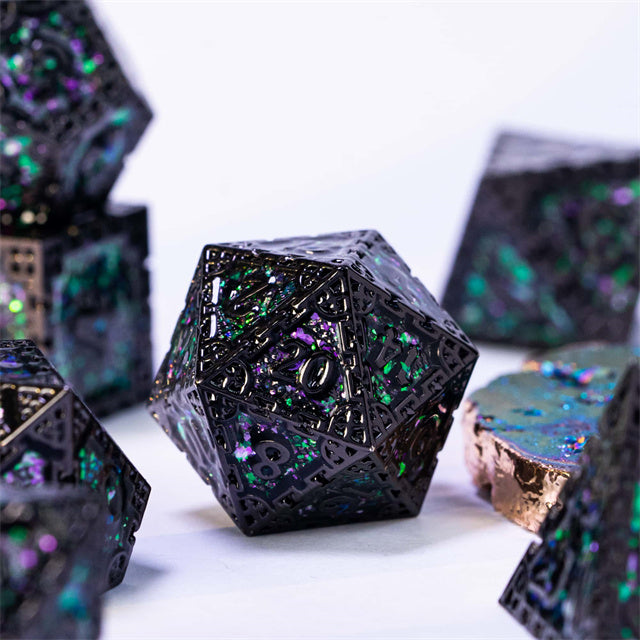 Pink Cathedral Glass Metal Dice Set - Black metal d20 die with iridescent pink and green cathedral glass inlays, detailed edges.